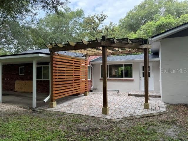 Photo 12 of 13: SIDE PAVER DECKWITH PERGOLA
