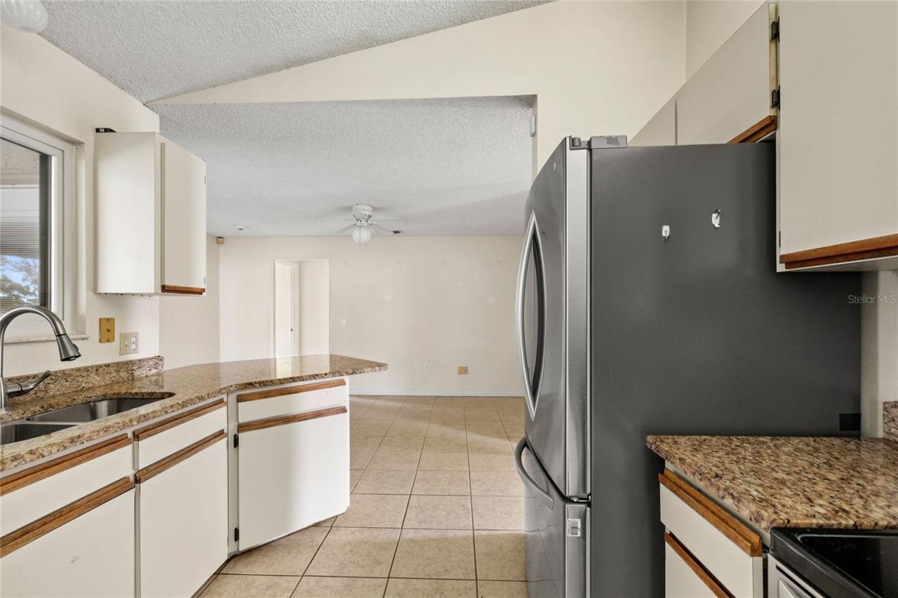 Photo 4 of 20: Kitchen with stainless steel appliances and granite counters.
