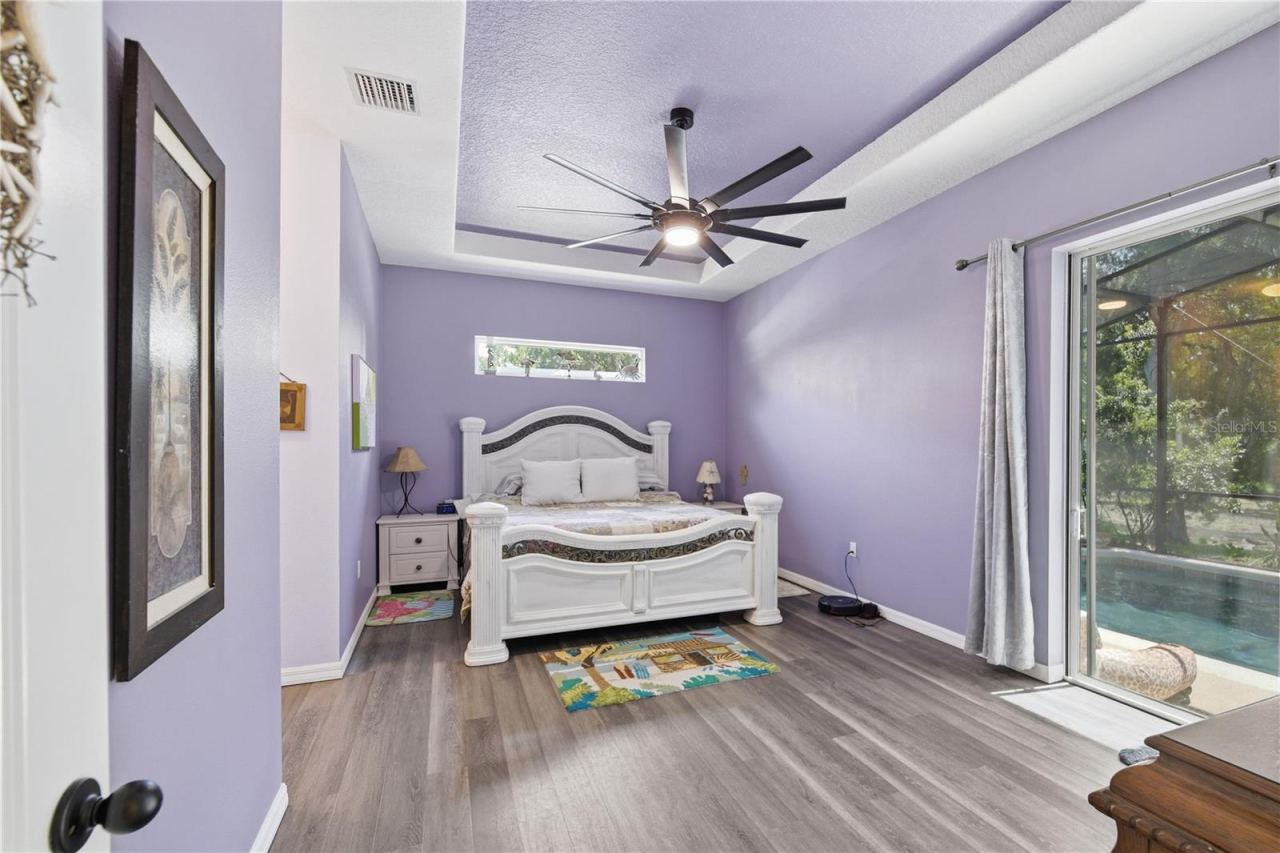 Photo 18 of 20: Main bedroom with a tinted sliding door that takes you out to the pool. The window over the bed lets in lots of light.