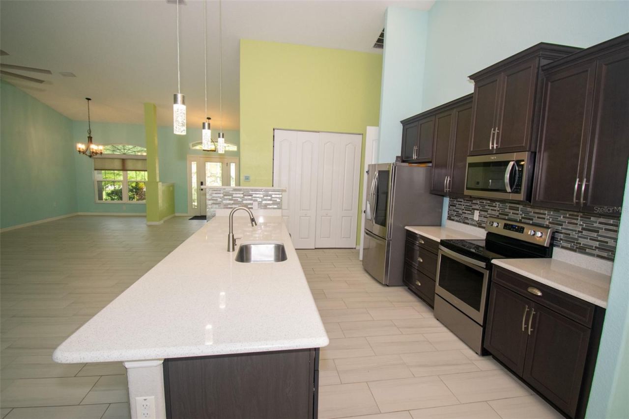 Photo 7 of 20: Spacious island kitchen featuring stainless steel appliances and a convenient walk-in pantry.