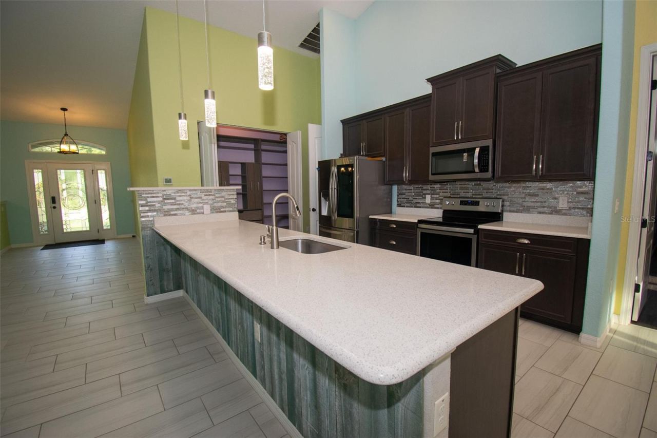 Photo 6 of 20: Kitchen and front door entrance.