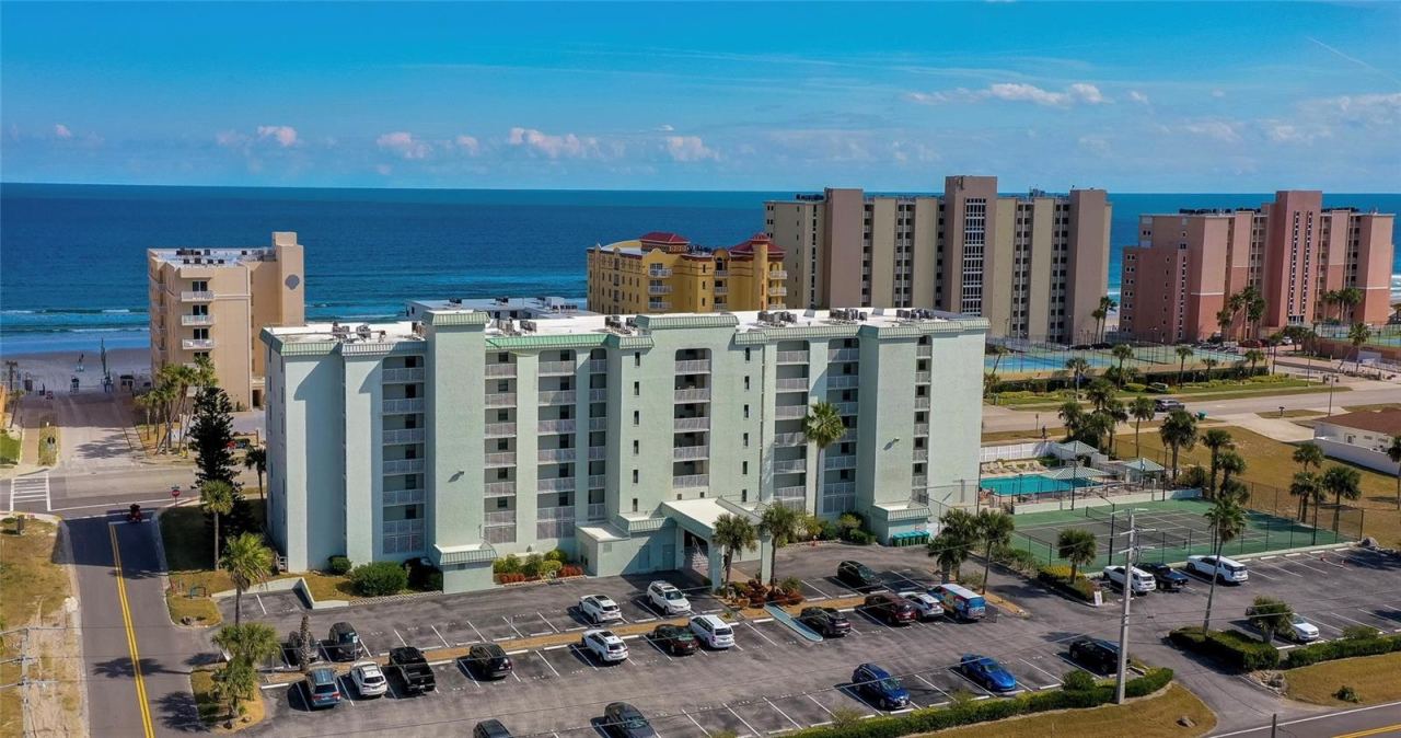 Photo 1 of 20: Aerial view of this well-maintained coastal condominium, ideally positioned just steps from the shoreline with convenient on-site parking and nearby amenities.