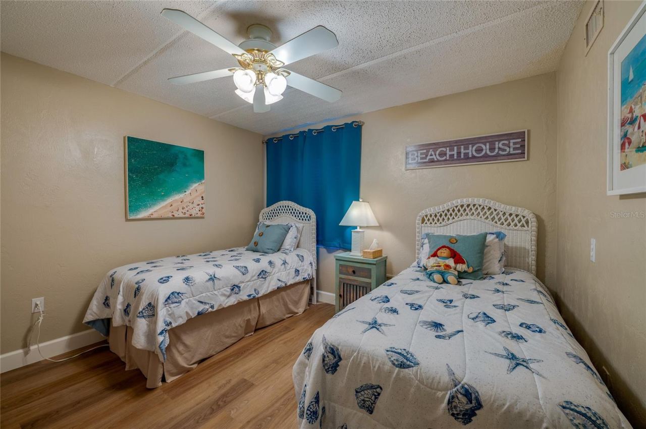 Photo 19 of 20: Comfortable Bedroom 2 , neutral tones, and vinyl plank flooring, offering a flexible space for guests or additional use.