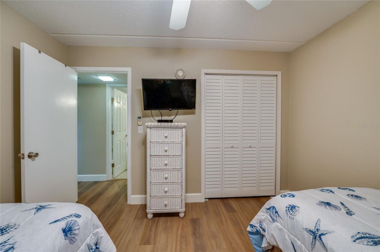 Photo 20 of 20: Additional view of Bedroom 2 featuring ample closet space and easy access to the hallway and bathroom.