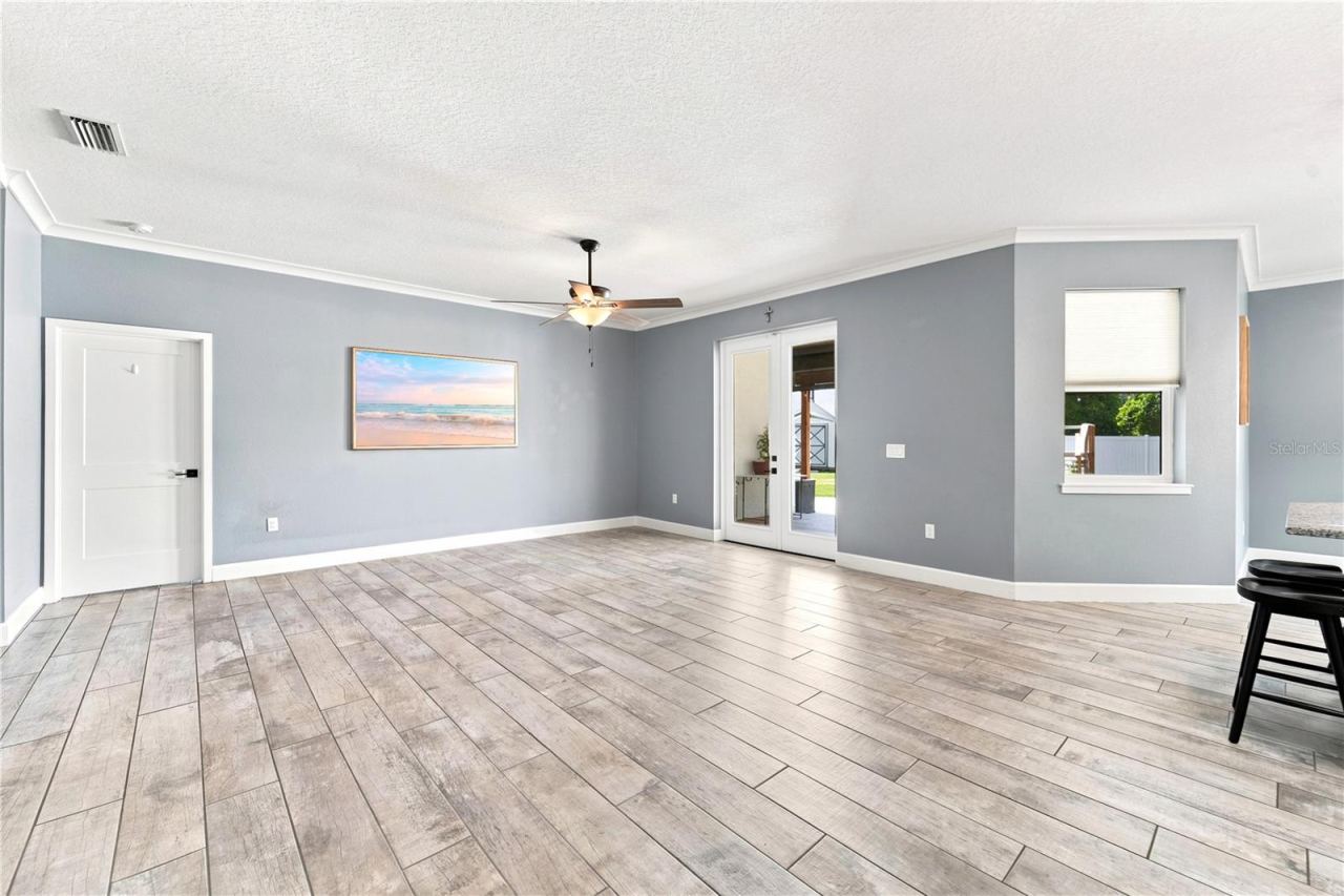Photo 3 of 20: Living Room leading to the primary bedroom and exterior portion of the home.