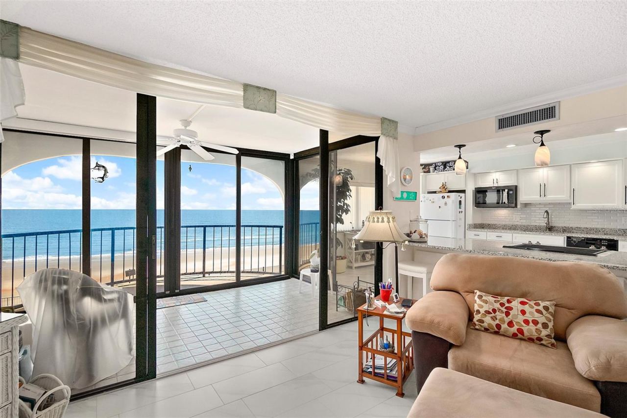 Photo 9 of 20: Large living room with covered lanai and balcony