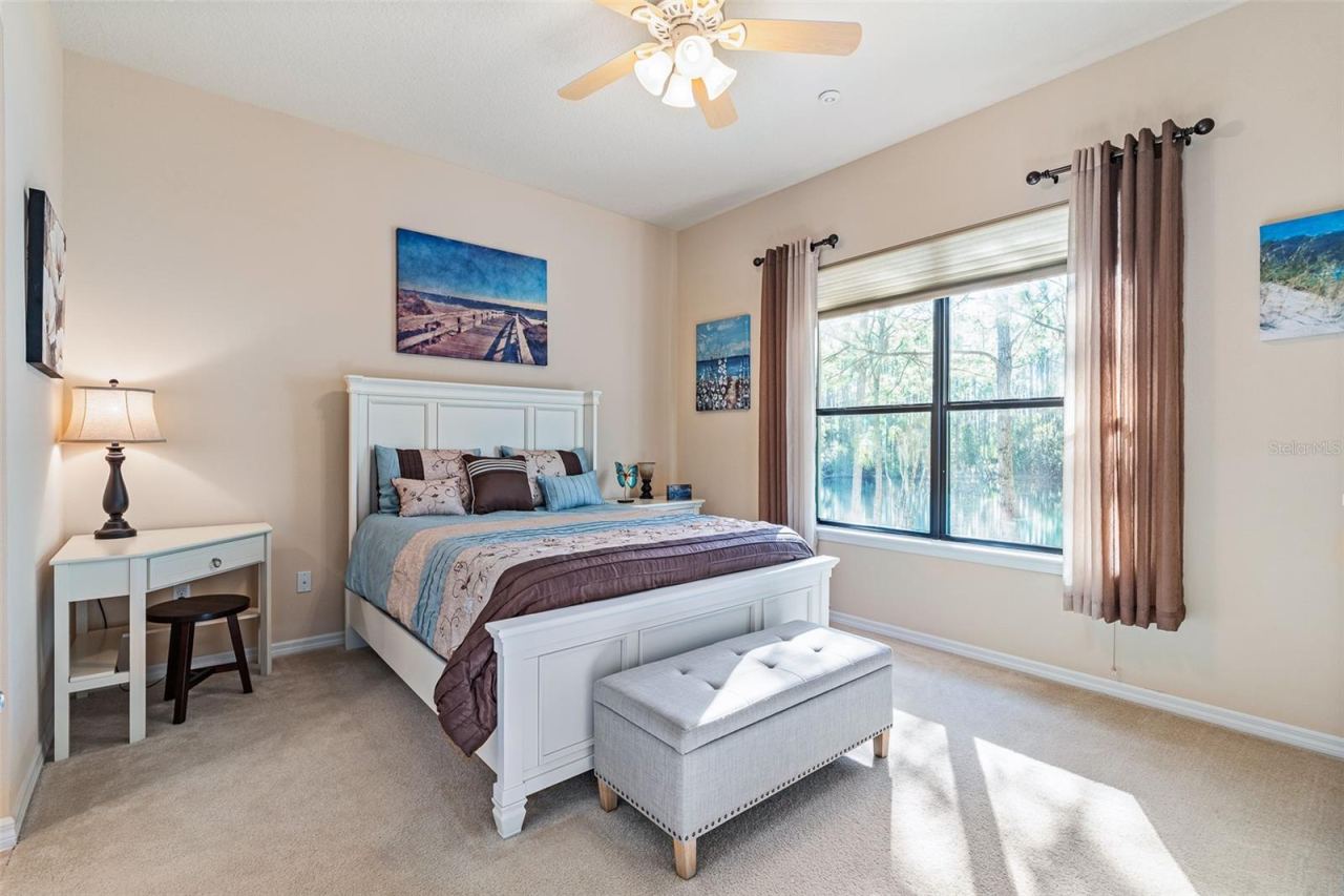 Photo 16 of 20: Primary Bedroom w/Large Window & Custom Drapes