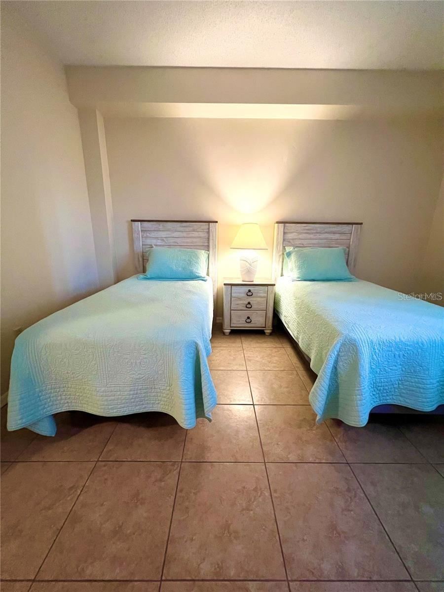 Photo 19 of 20: Second bedroom with twin beds and large window