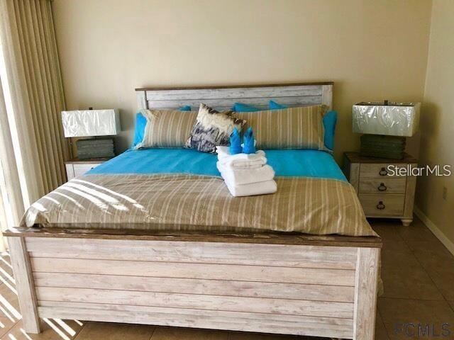 Photo 11 of 20: Primary Bedroom-King bed-sliders to balcony, two walk-in closets. Ensuite bathroom