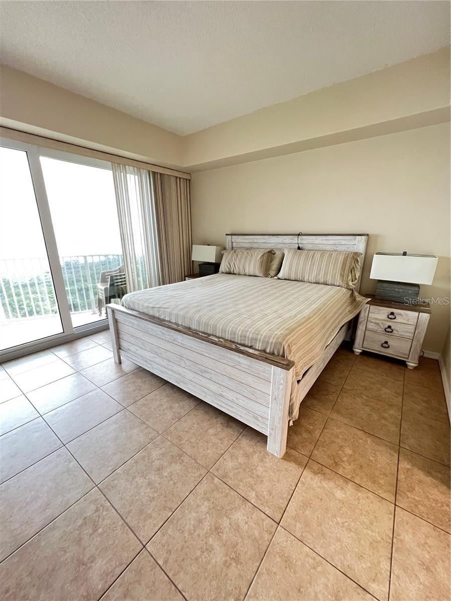 Photo 15 of 20: Primary Bedroom-King bed-sliders to balcony, two walk-in closets. Ensuite bathroom