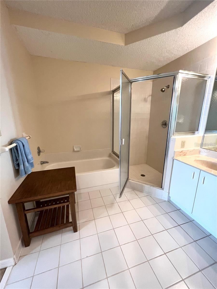 Photo 17 of 20: Ensuite primary bathroom. Tile walk on shower, separate tub, double sinks