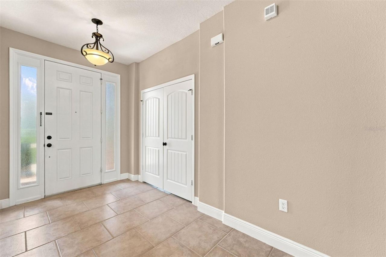 Photo 15 of 20: Foyer leading to front door and bonus room.