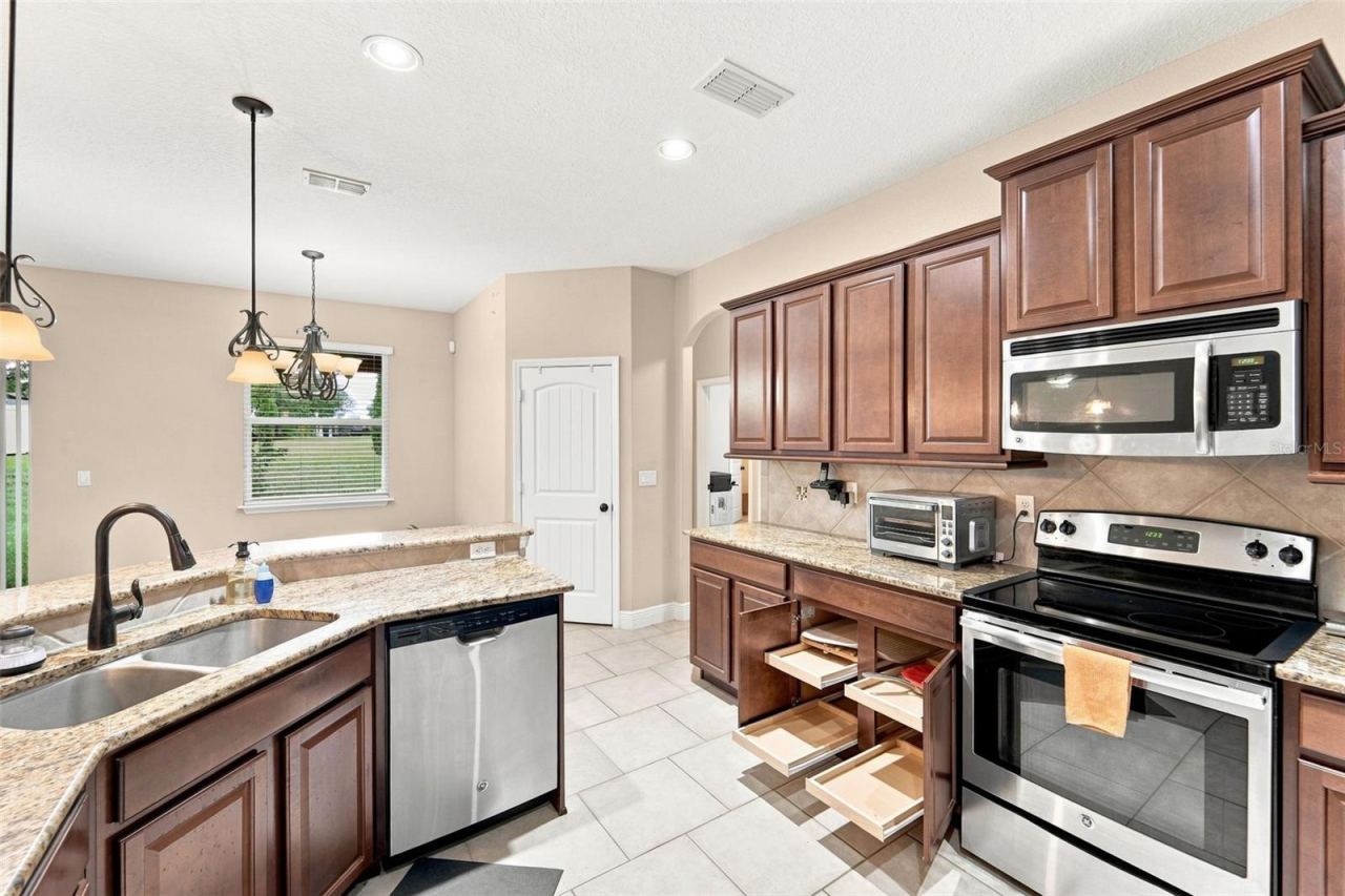 Photo 6 of 20: Spacious kitchen w/slide out storage and large pantry.