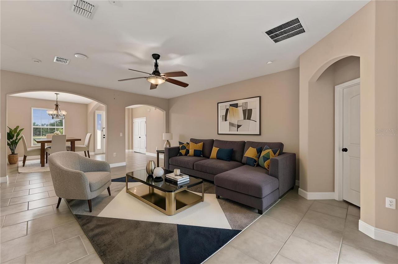Photo 3 of 20: Virtually staged Living area towards front entrance and dining area.