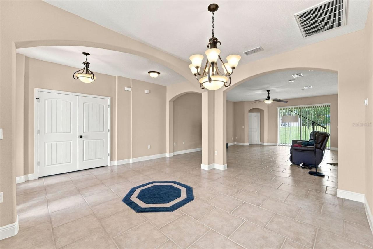 Photo 10 of 20: Dining area view towards den and living room. Bonus room through doors at left.