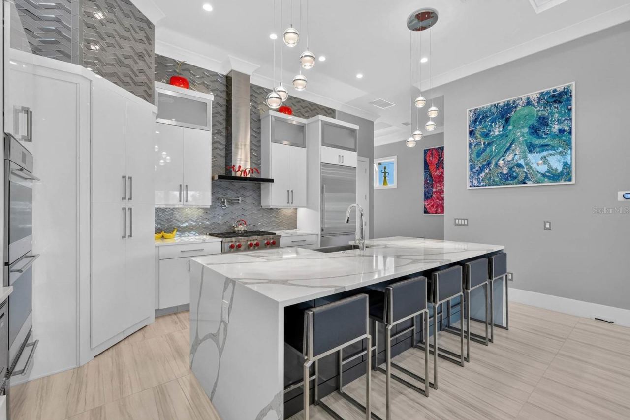 Photo 20 of 20: The island is where everyone ends up anyway. Generous seating, abundant prep space and an open layout make this kitchen as social as it is functional.