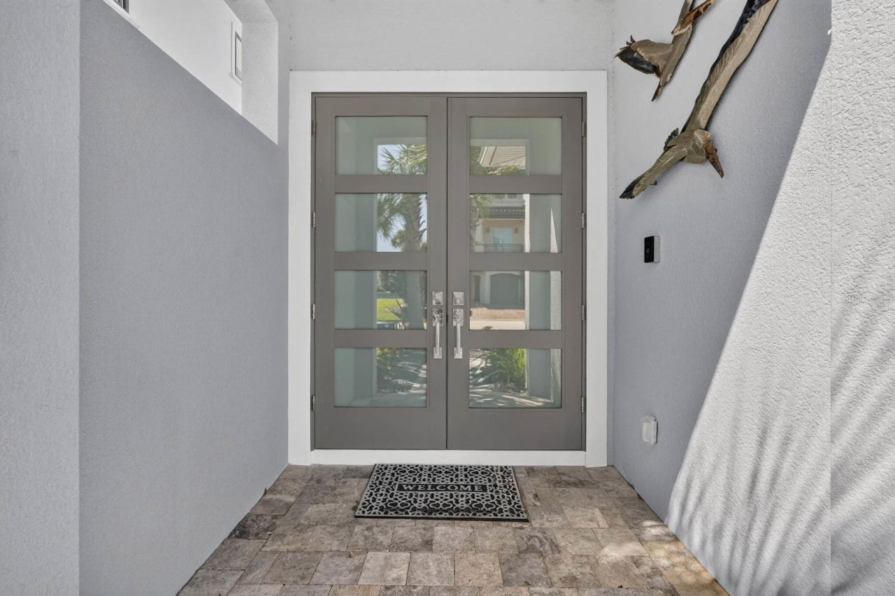 Photo 14 of 20: The details begin at the front door. Contemporary double-door entry sets the tone for the custom finishes found throughout the home.