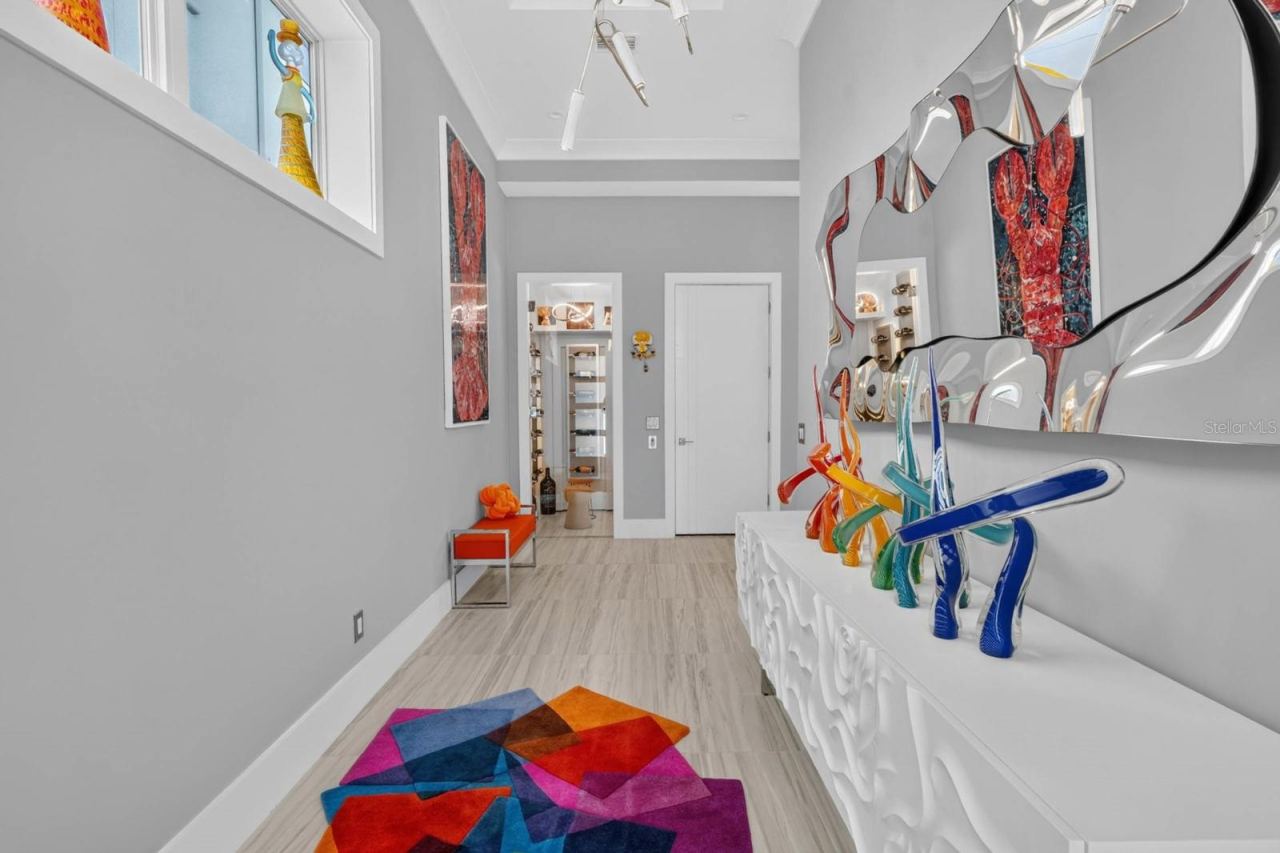 Photo 16 of 20: A gallery-like arrival. Soaring ceilings, statement lighting and custom finishes lead you toward one of the home’s unexpected details...the dedicated wine room.