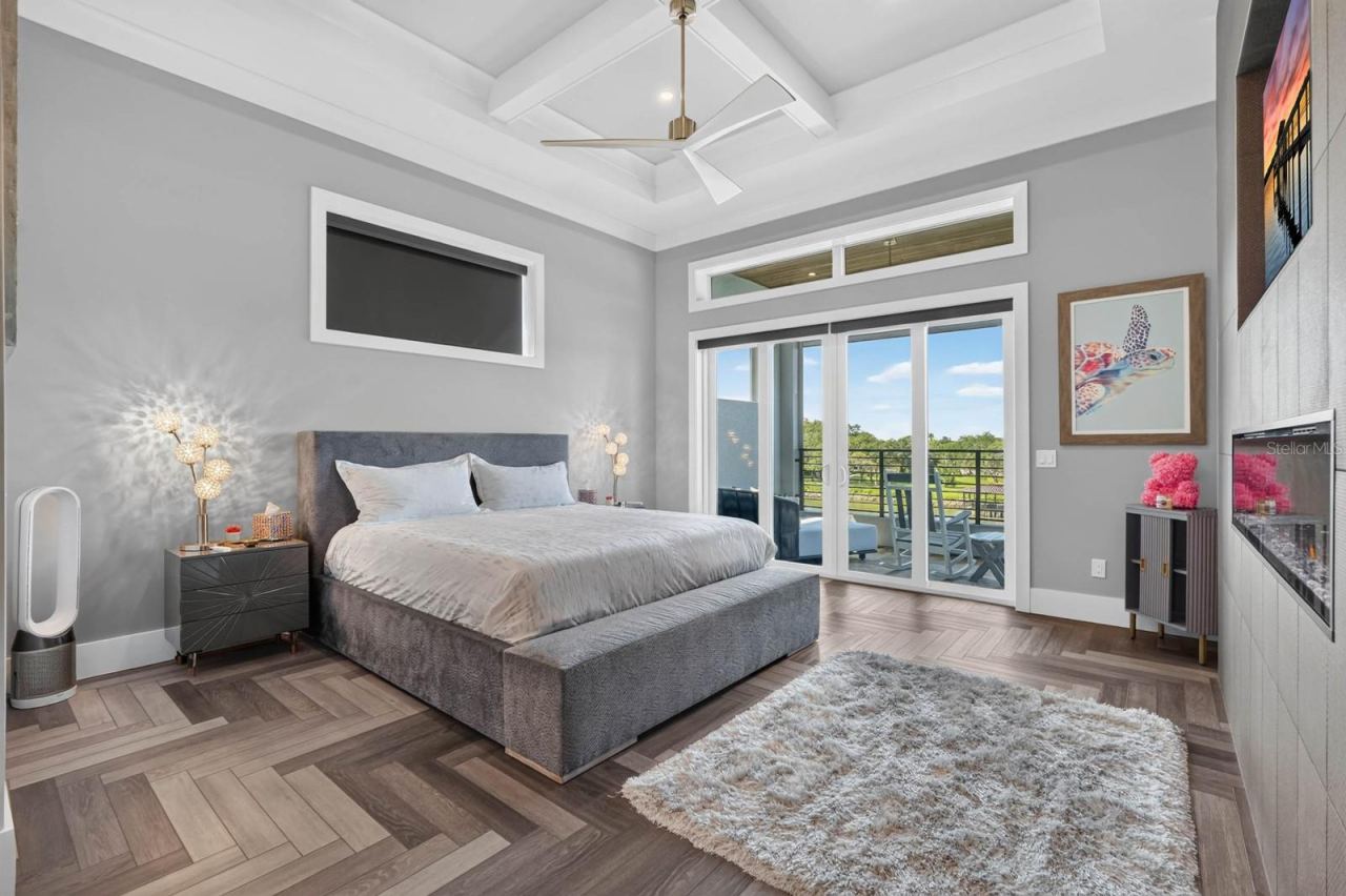 Photo 10 of 20: Wake up to the water.A spacious primary suite with architectural ceilings, fireplace and direct access to its own covered balcony.
