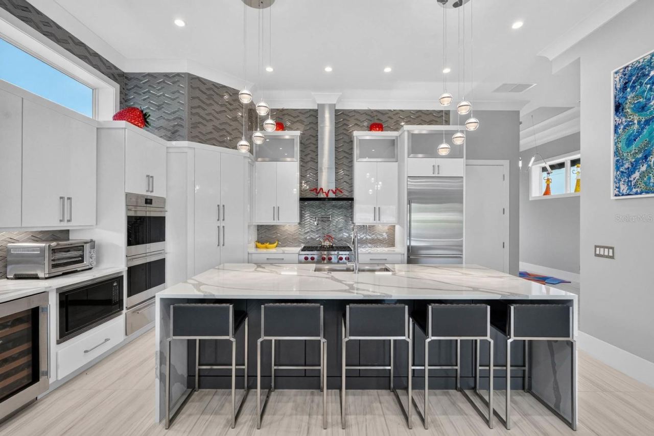 Photo 19 of 20: A kitchen designed without compromise—Sub-Zero refrigeration, Wolf cooking, built-in wine storage, abundant cabinetry and dramatic ceiling-height finishes create a space that is both polished and highly functional.