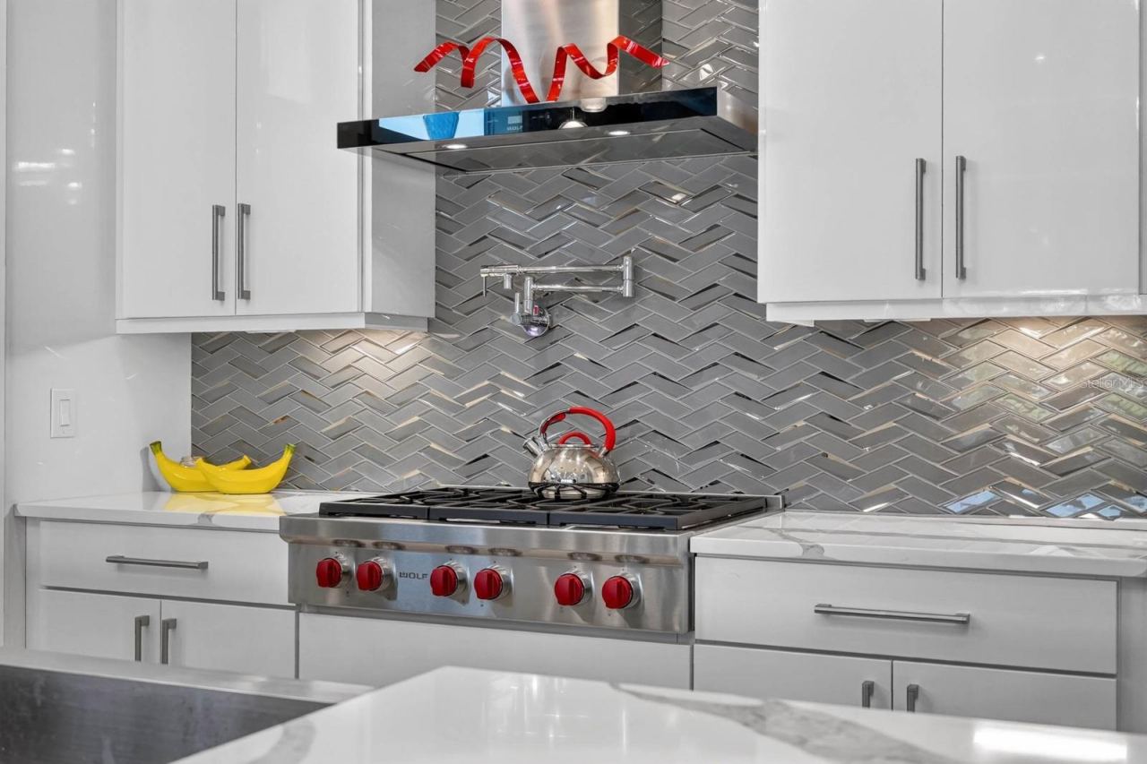 Photo 18 of 20: Wolf gas range, pot filler, custom cabinetry and a striking herringbone backsplash pair professional-grade function with polished design.