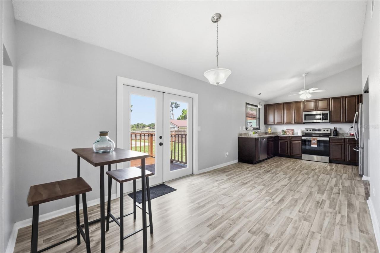 Photo 11 of 20: Kitchen w/dinette area. French doors lead out to the backyard deck.