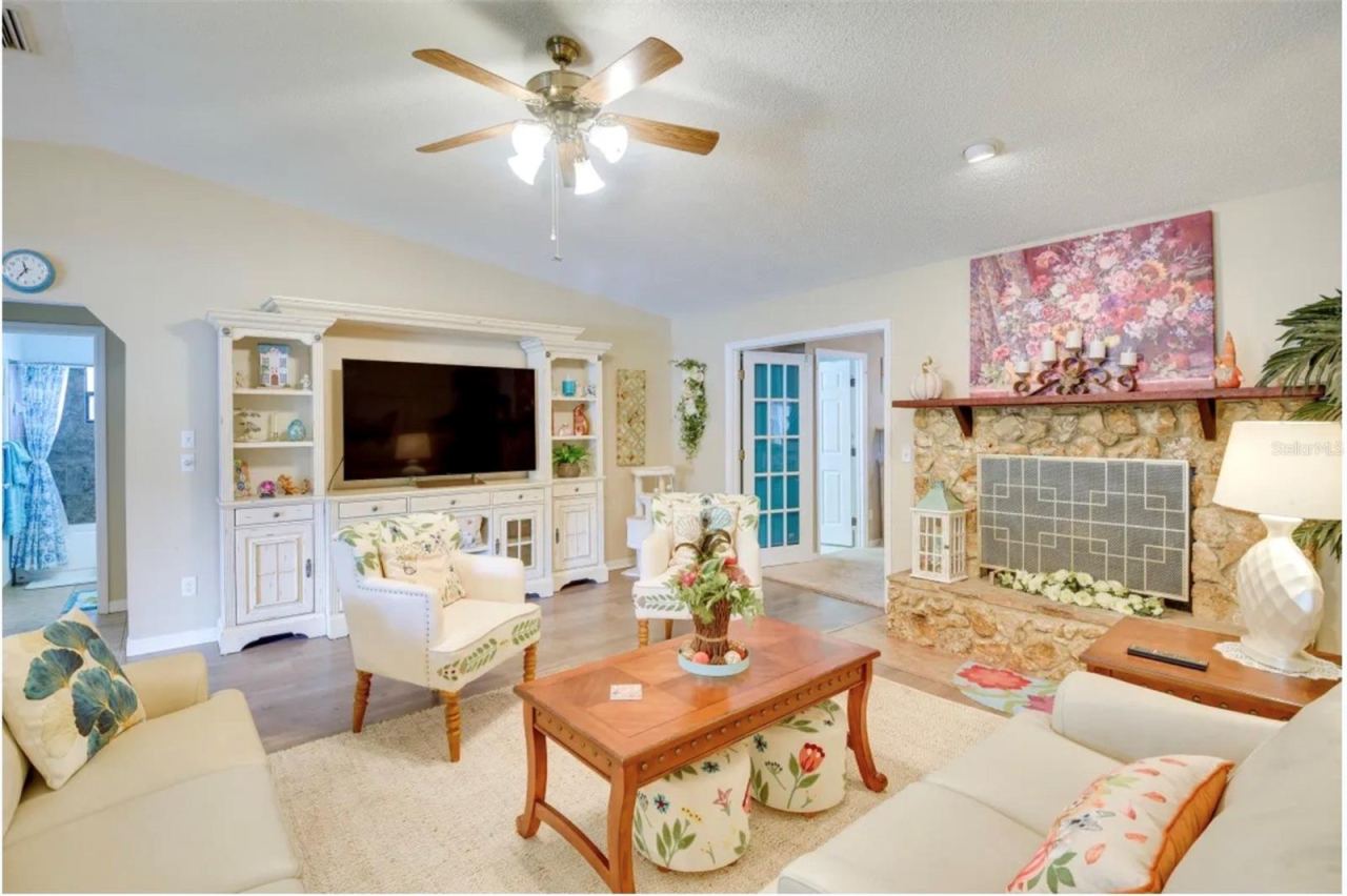 Photo 5 of 20: Open floorplan with FPL & wood floors in DR area.