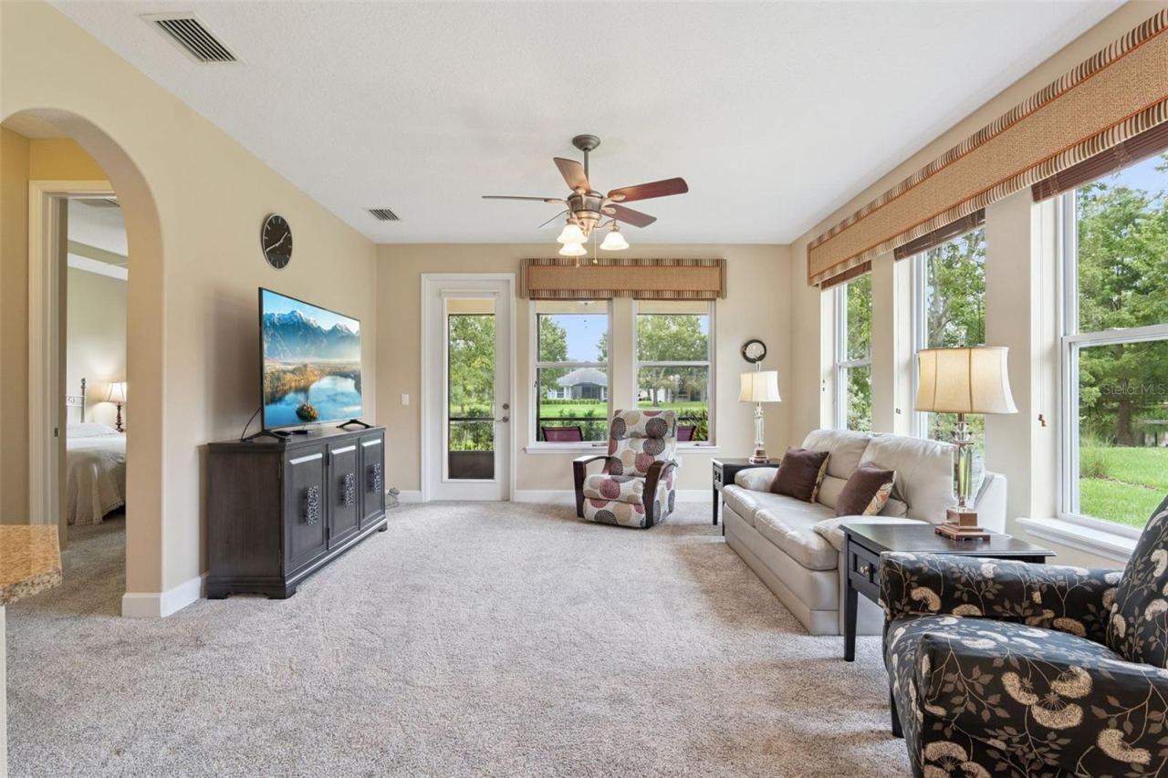 Photo 11 of 20: 14'6" x 16'6" Great Room area w/ multiple windows & a ceiling fan