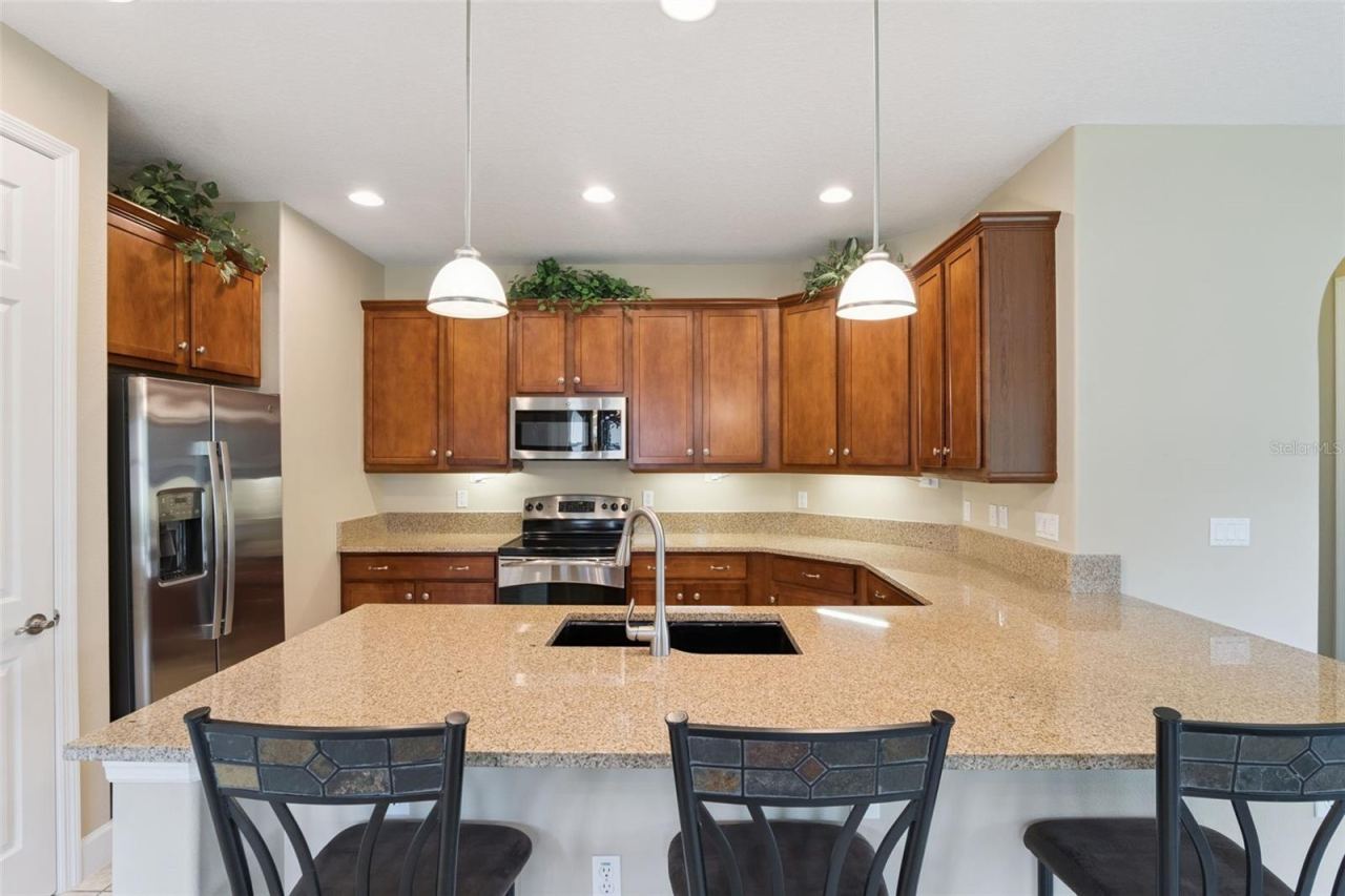 Photo 8 of 20: Kitchen breakfast bar w/ pendant lighting above