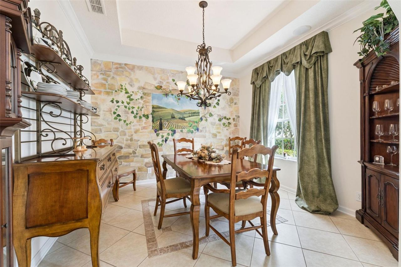 Photo 6 of 20: 11'6" x 12' Dining Room w/ tray ceiling, crown molding & a decorative tile border & accent wall