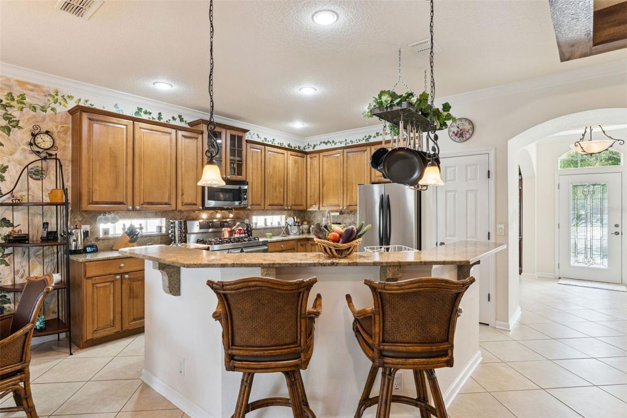 Photo 11 of 20: View of the Kitchen & breakfast bar w/ pendant lights above