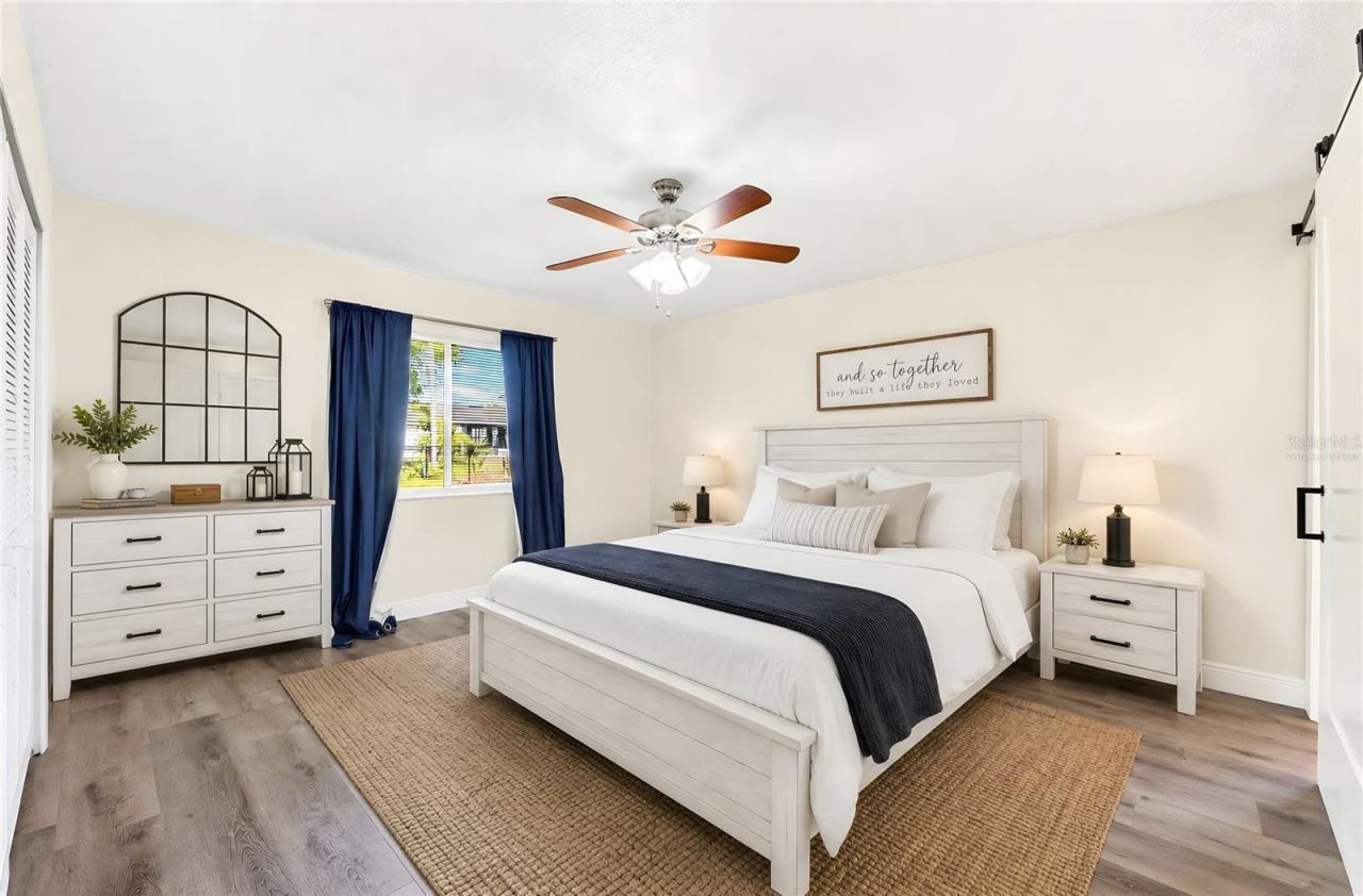 Photo 10 of 20: The Primary Suite offers privacy and comfort, complete with a large built-in closet and an en suite bath accented by a STYLISH BARN DOOR. Virtually Staged