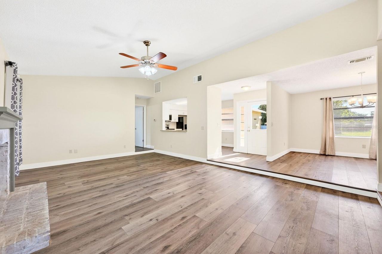 Photo 5 of 20: The open-concept floor plan connects the Living Room to the Dining Room and Kitchen.