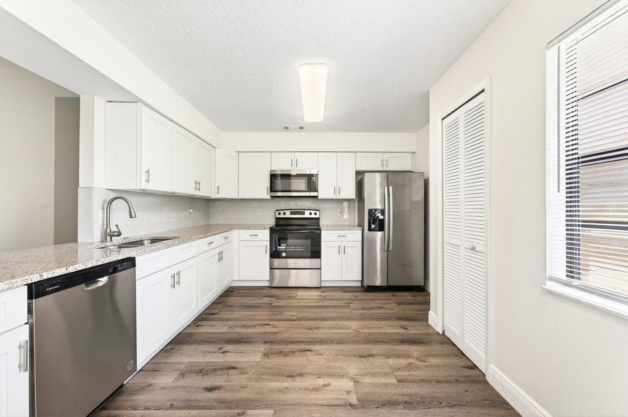 Photo 8 of 20: A convenient PASS-THROUGH WINDOW to the Living Room makes the space feel even more open and connected.
