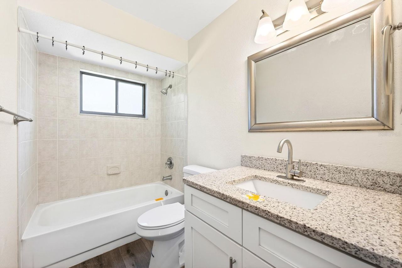 Photo 14 of 20: A split-bedroom floor plan places the two additional bedrooms and SECOND FULL BATH on the opposite side of the home, providing flexibility for family, guests, or a home office.