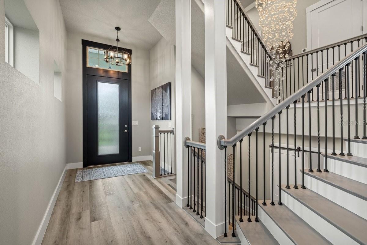 Photo 9 of 20: Rich in luxury and sophistication, this impressive second-floor foyer showcases soaring ceilings, custom iron railings, and a dazzling statement chandelier that instantly elevates the entire home.