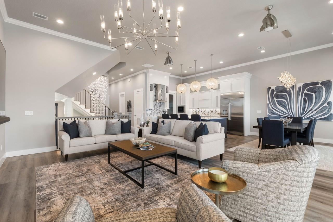 Photo 14 of 20: The expansive open living area shines with incredible designer lighting, creating a warm yet dramatic atmosphere perfect for both relaxed living and stylish entertaining.
