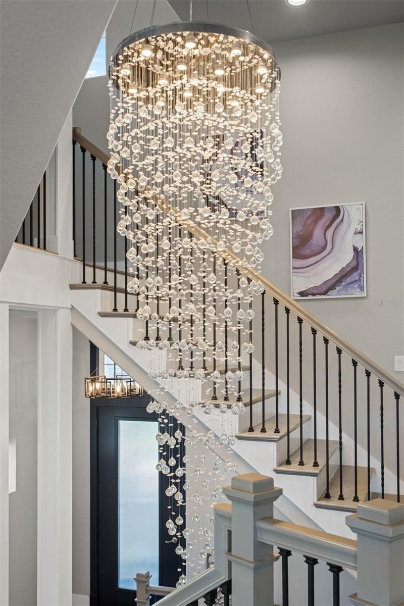 Photo 11 of 20: Inside… every detail feels intentional.From the moment you enter, the dramatic chandelier creates a breathtaking focal point, setting the tone for the sophisticated design, soaring ceilings, and expansive open living spaces that unfold beyond.