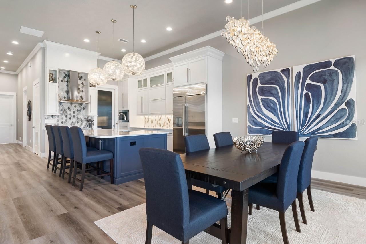 Photo 16 of 20: Dramatic designer lighting and bold coastal finishes make this stunning dining and kitchen space feel like the heart of every unforgettable gathering.