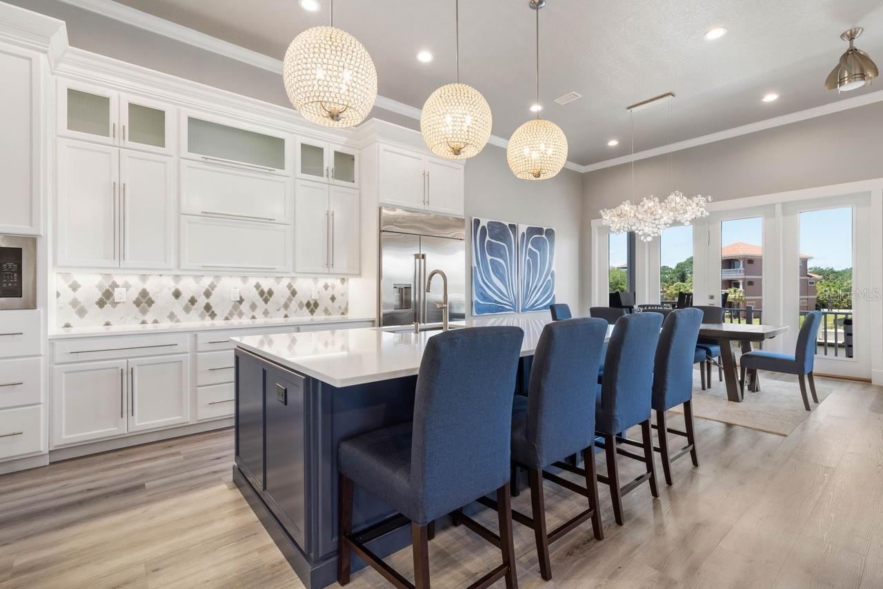 Photo 17 of 20: Stunning designer lighting, ample custom cabinetry, and an oversized gathering island make this impressive kitchen as functional as it is unforgettable.