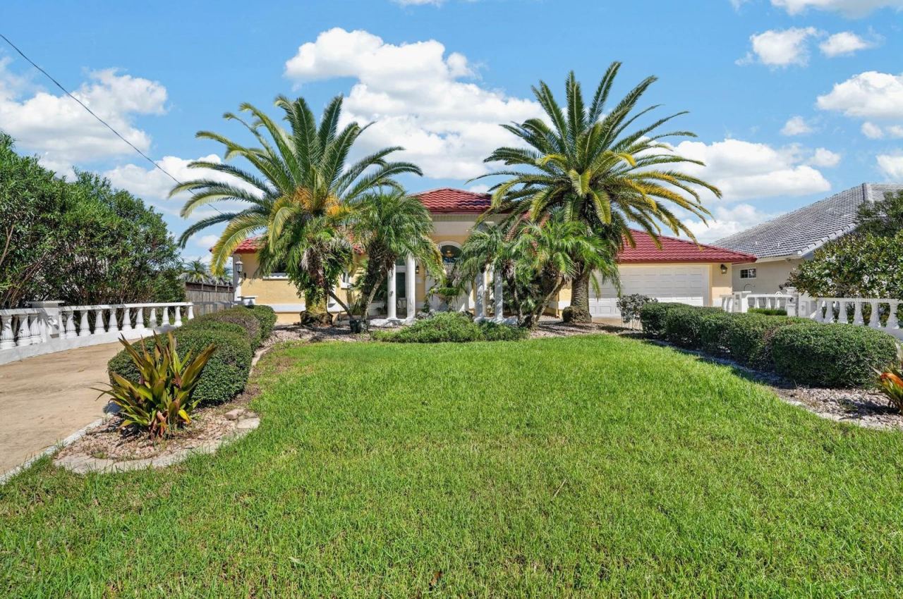 Photo 8 of 20: Welcoming Entrance with Tropical Landscaping