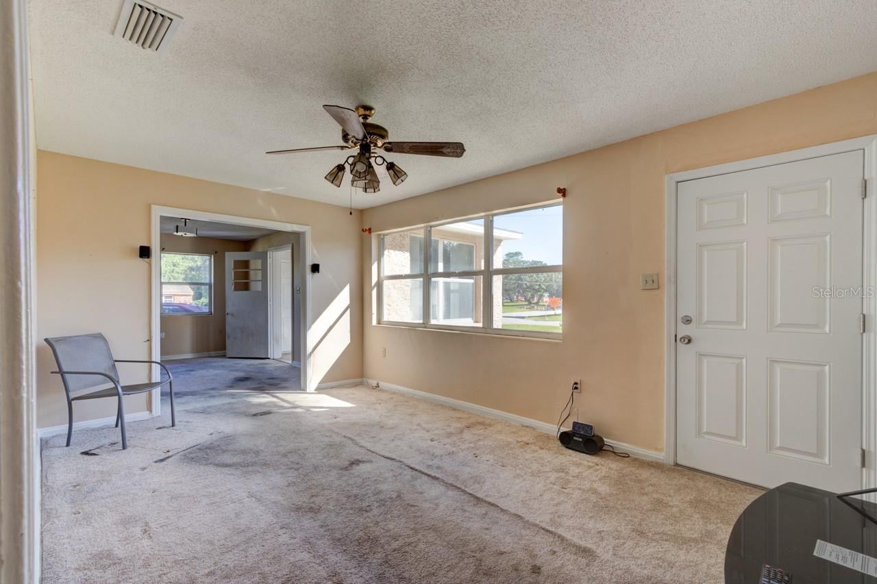 Photo 8 of 20: Living room with NE facing window and Front door entry