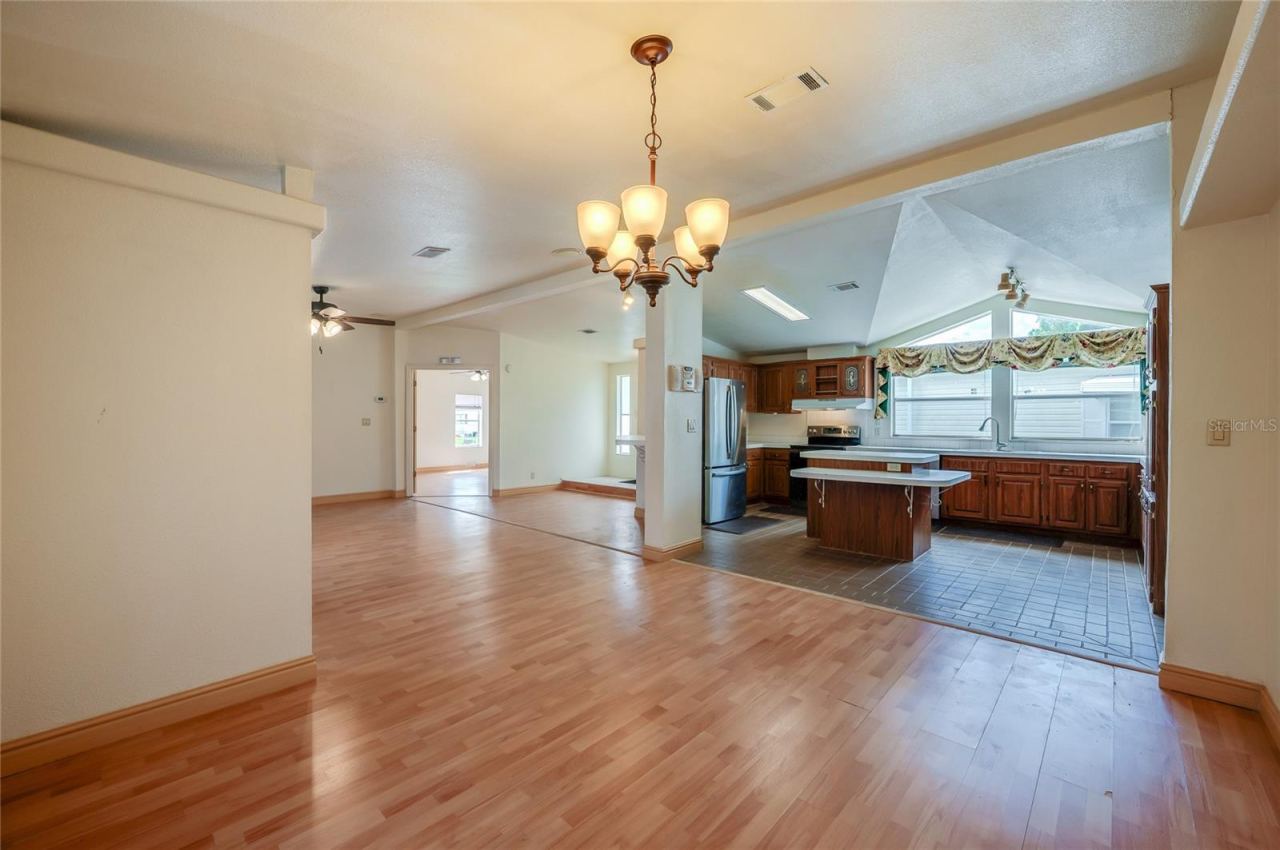 Photo 12 of 20: Open sightlines connect the dining area to the spacious kitchen, creating an easy flow between meal preparation, dining, and the main living space.
