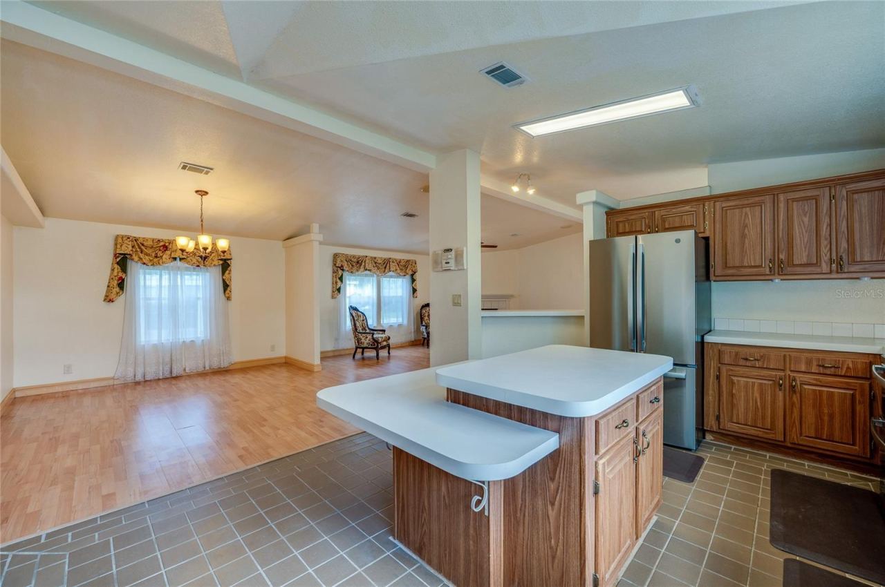 Photo 11 of 20: View from the kitchen highlights the center island and the open connection to the adjacent dining and living areas.