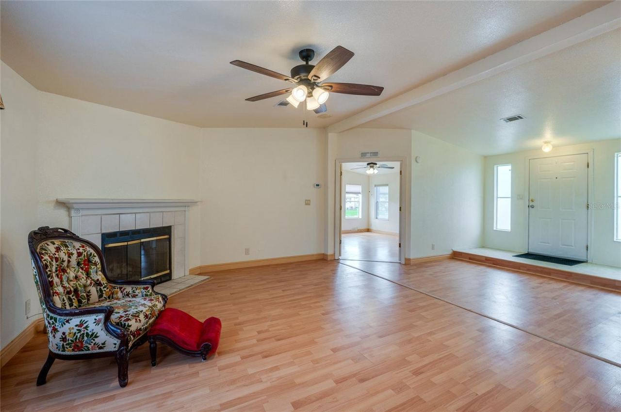 Photo 7 of 20: This angle showcases the home's open interior flow, with the fireplace anchoring the living room and the raised entry positioned just beyond.