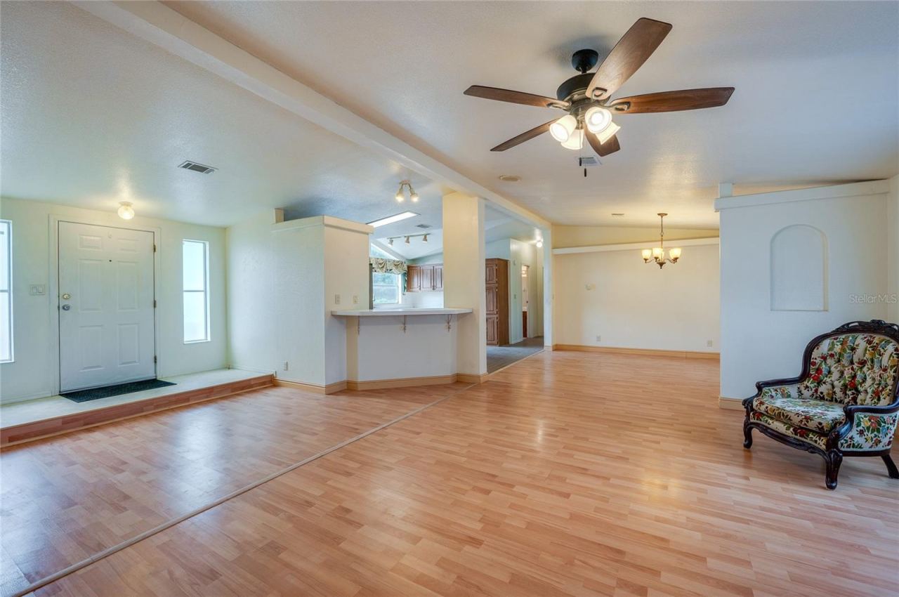 Photo 8 of 20: An expansive main living space connects the living room, dining area, and kitchen, creating a versatile layout for everyday living and entertaining.