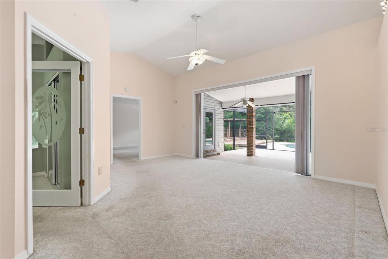 Photo 10 of 20: Sliding fully opened onto back patio. Office/bedroom #3 on right, primary straight ahead.