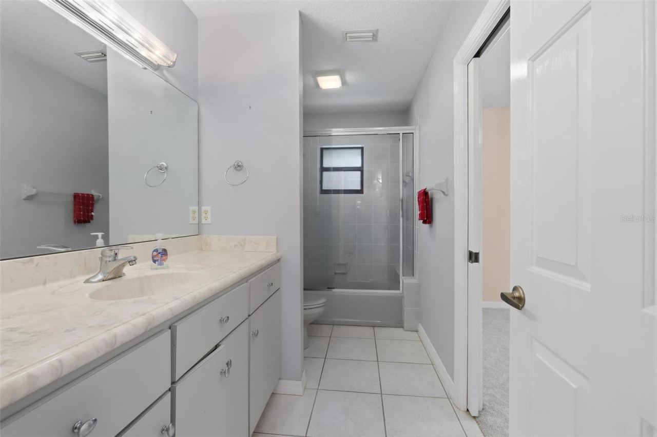 Photo 13 of 20: Bathroom #2 (hall). Additional entrance on right into bedroom #2.