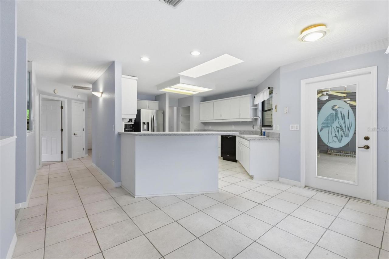 Photo 20 of 20: Kitchen on right. Door to patio. Bedroom #2 straight ahead.