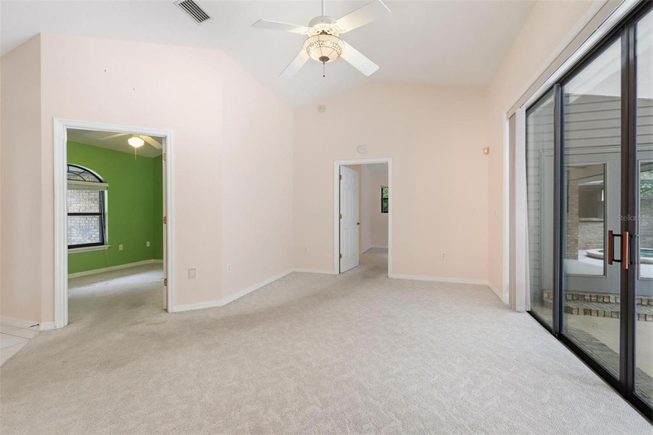 Photo 8 of 20: Living room looking into bedroom #3/office and primary bedroom. Sliders on right completely "pancake" into wall.